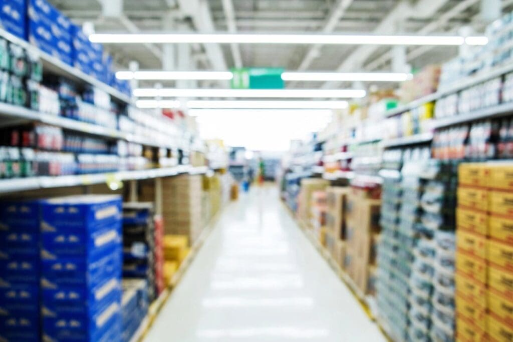 A blurry image of a aisle in a grocery store.