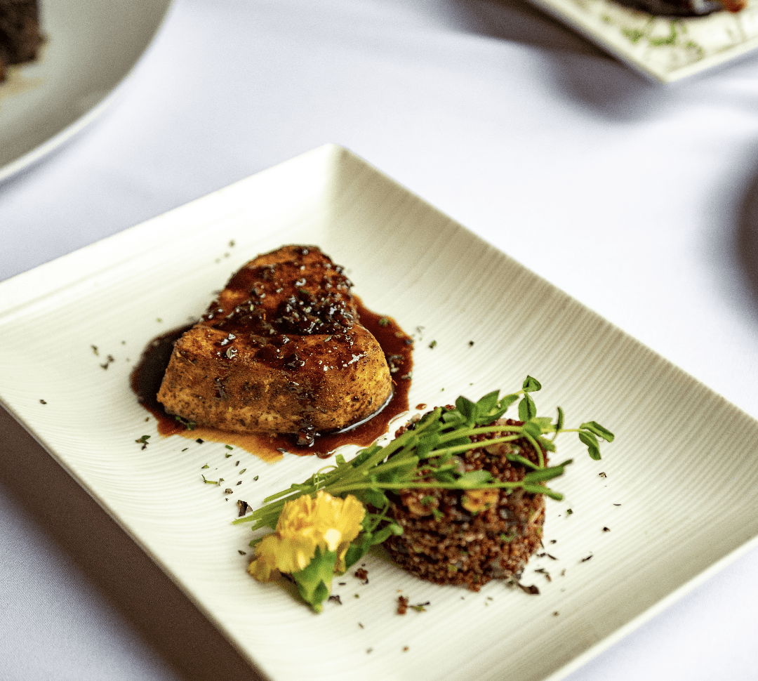 A plate of food with recipes on a table.