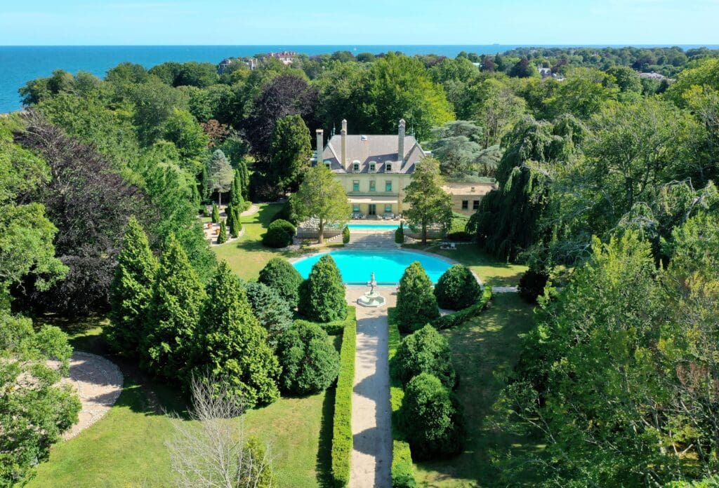 Oceanfront mansion with pool and gardens.