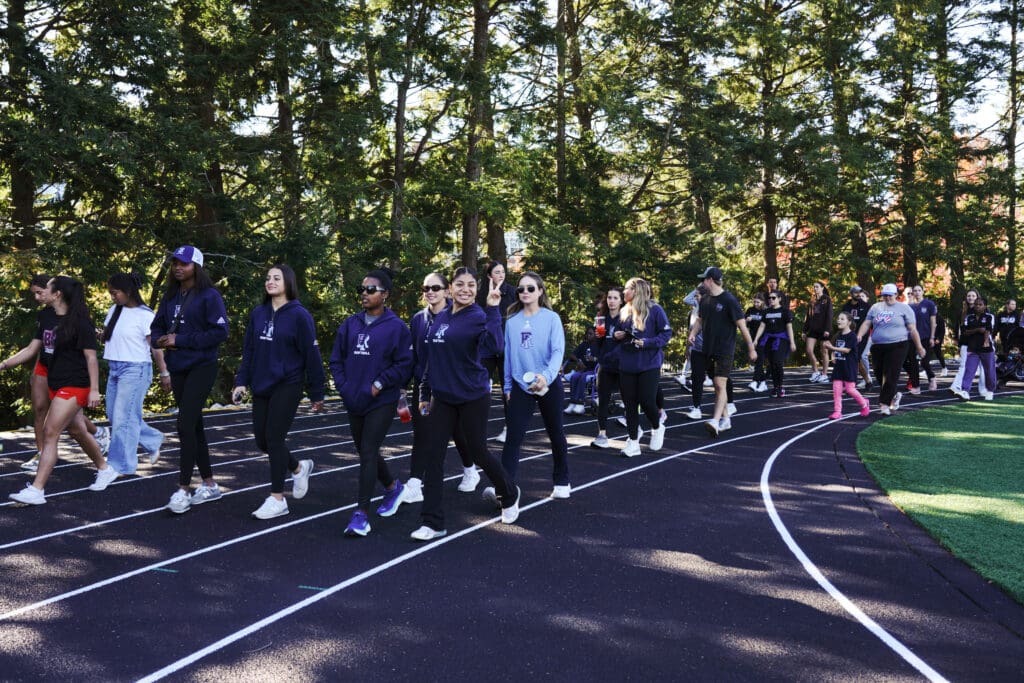 Group walking on a track outdoors.