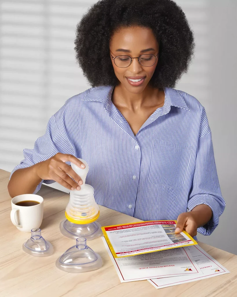 Woman assembling suction device and reading instructions.