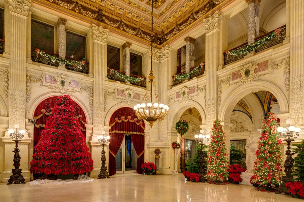 A large room with many christmas trees in it