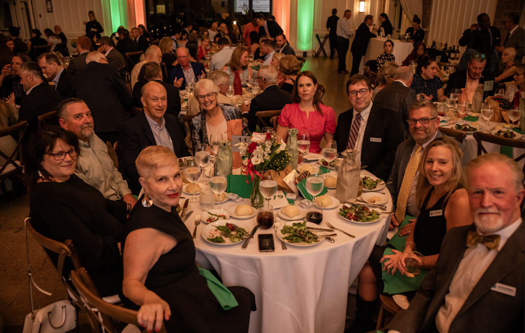 A group of people sitting at a table with food.