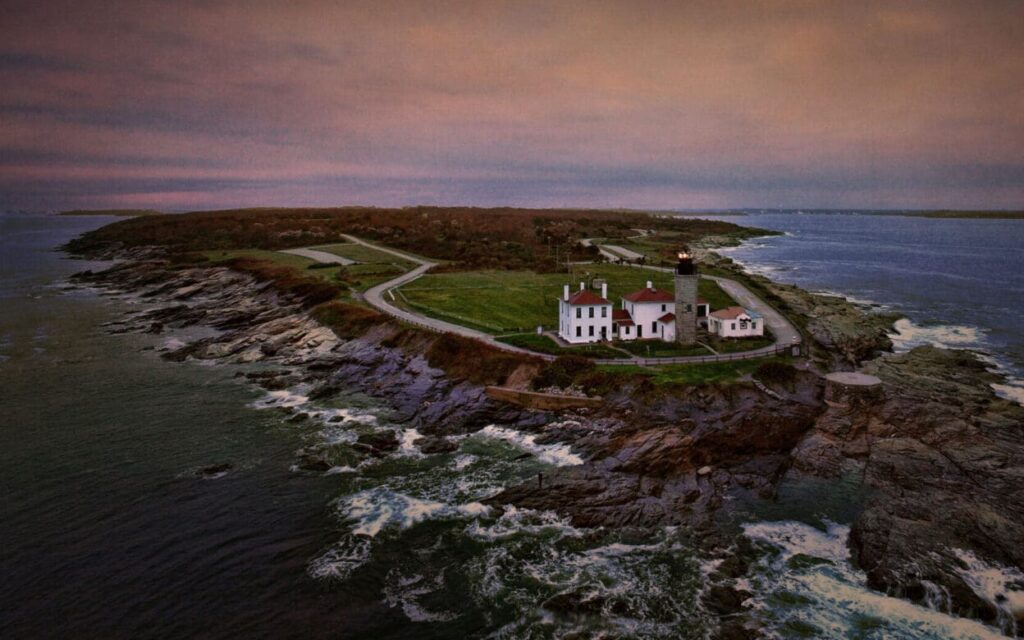 A large house on the edge of an ocean.