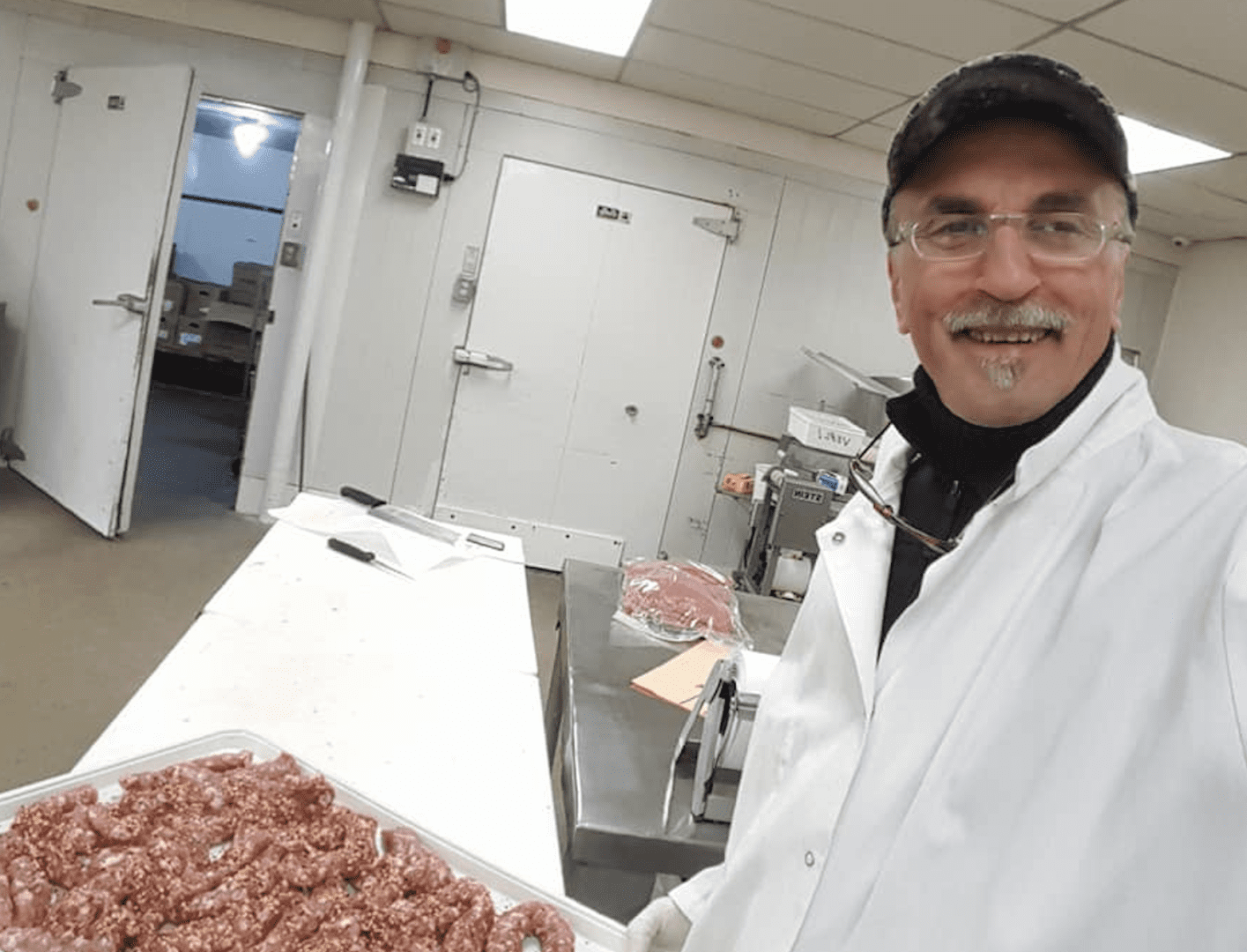 Screen Shot 2024-12-28 at 7.09.17 AM A man in white lab coat holding a box of meat.