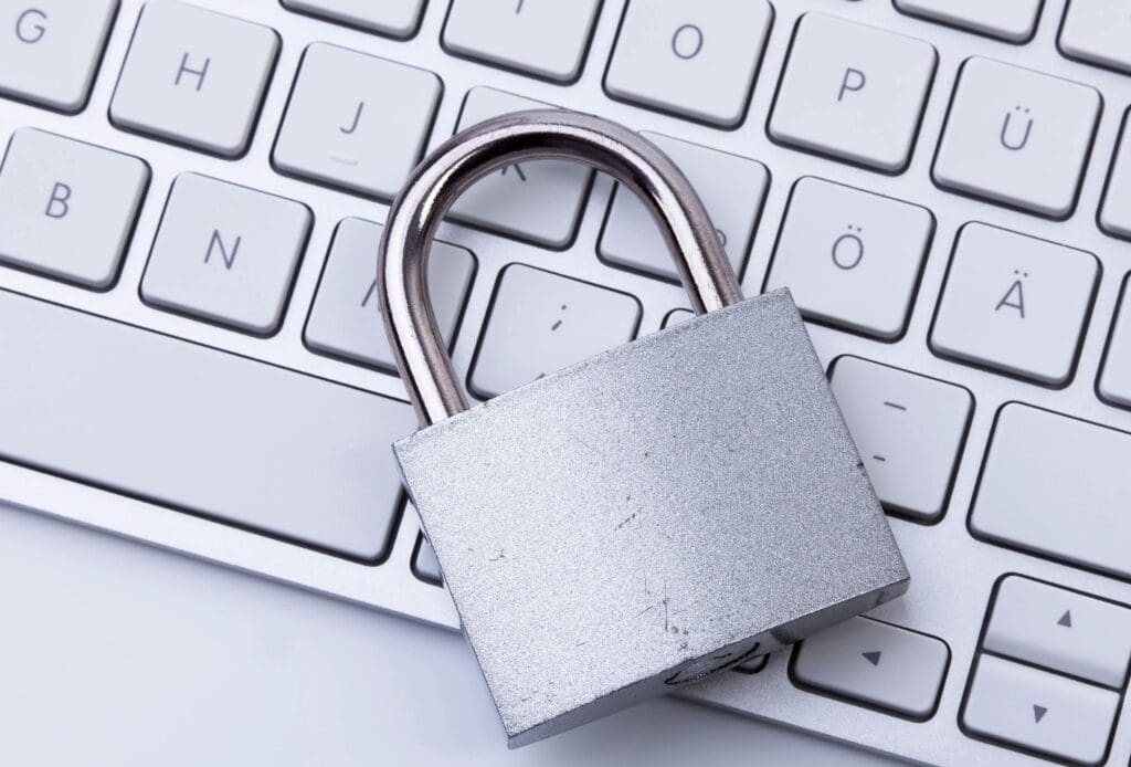 A padlock sitting on top of a keyboard.