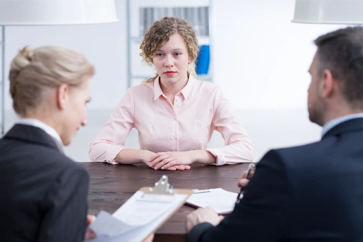 A woman sitting at a table with two other women.