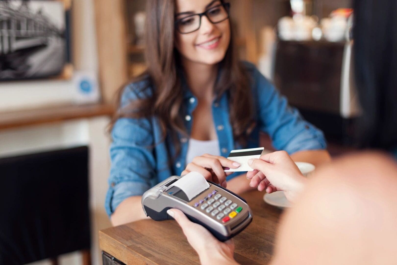 A woman is paying for something at the table