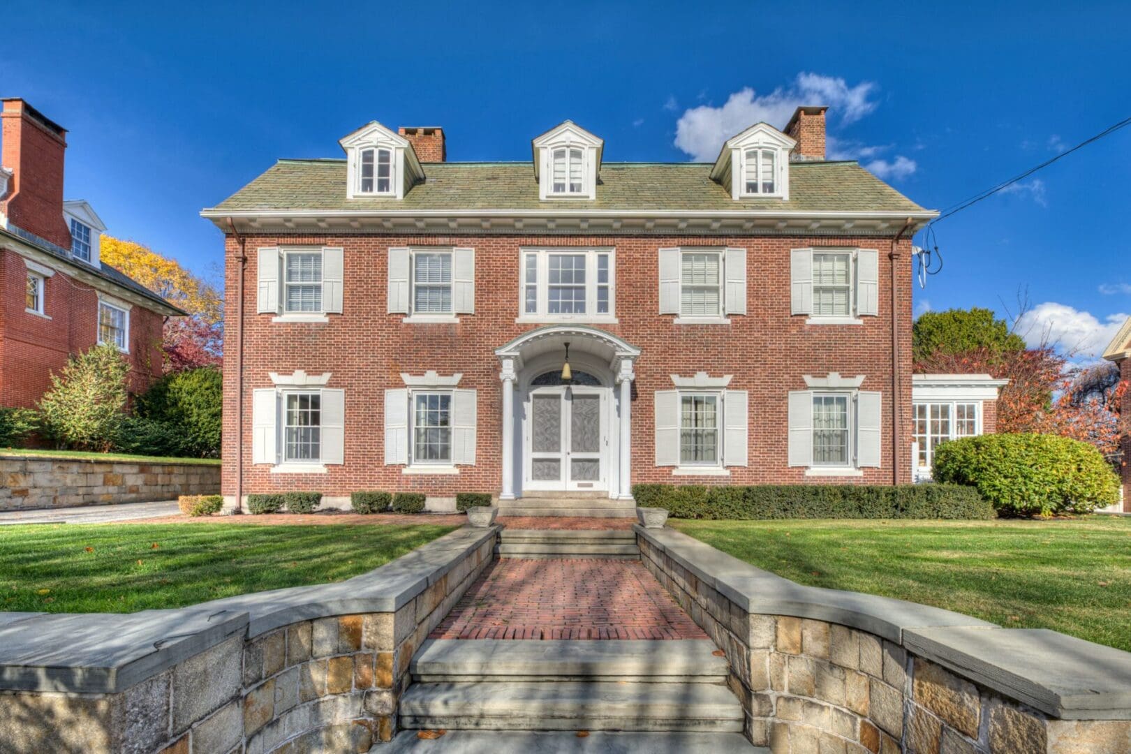 A brick house with steps leading to the front door.