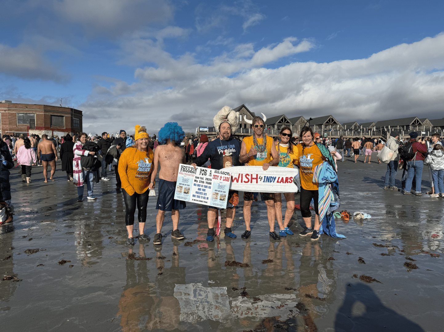 A group of people standing on top of a beach.