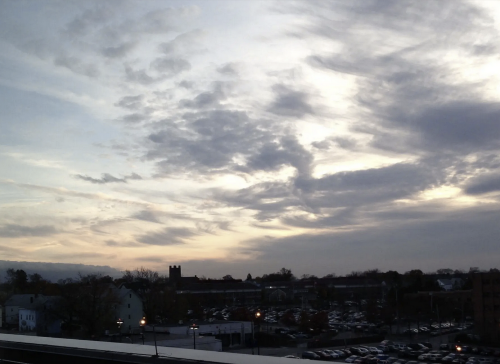 A black and white photo of the sky with clouds.