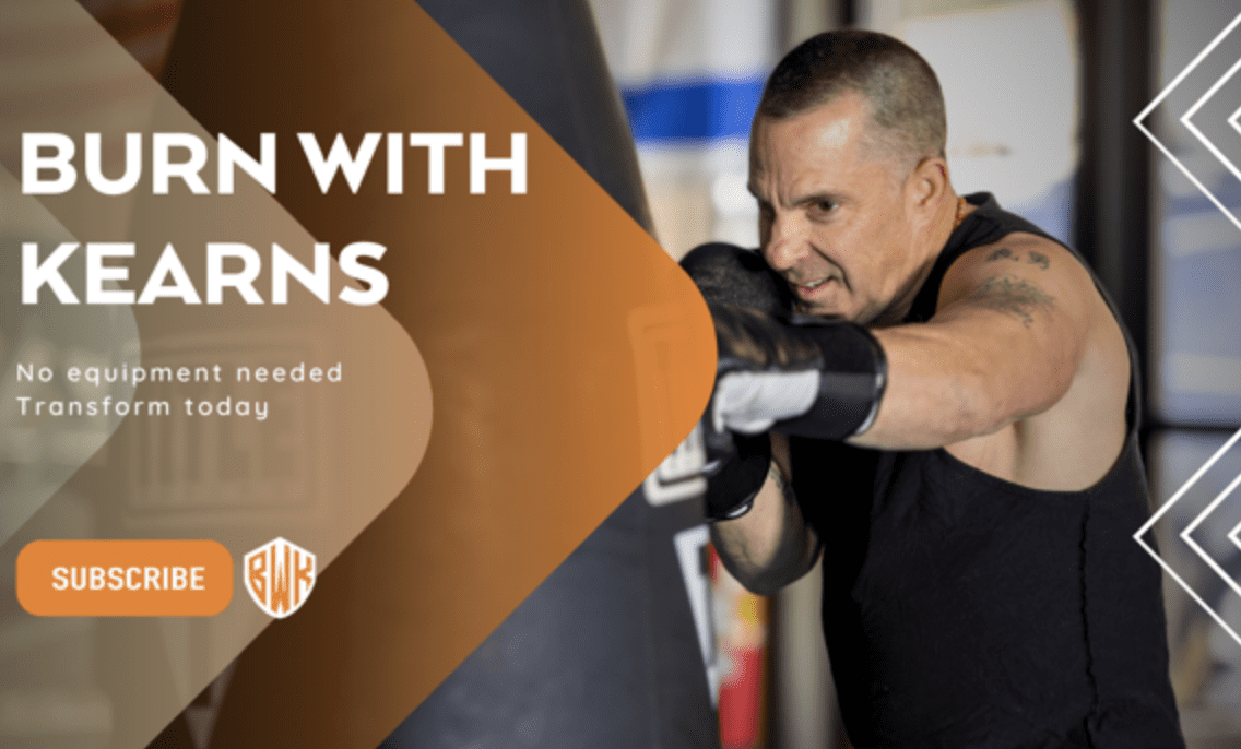 A man is boxing in the gym with his arms out.