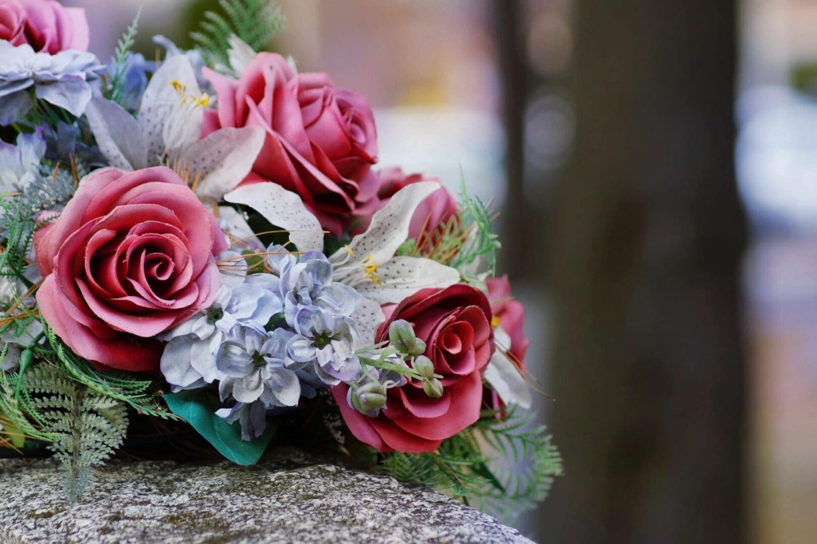 A bouquet of flowers on top of a stone slab.