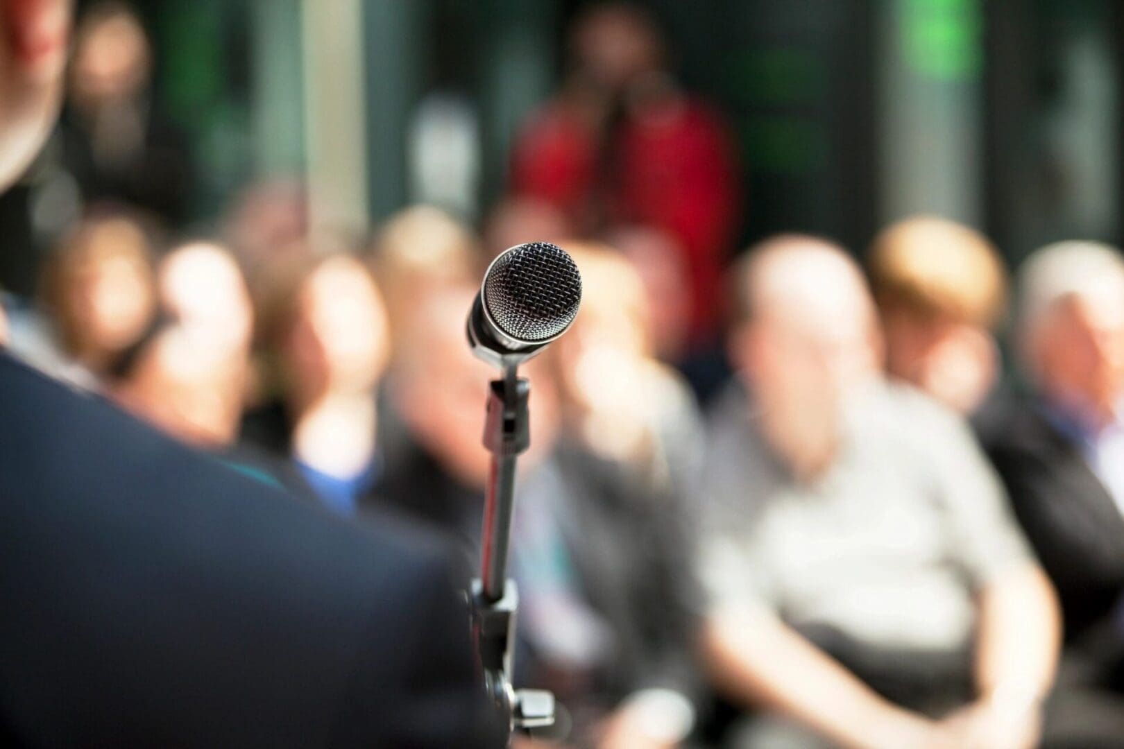 A microphone is pointed at the audience in front of them.