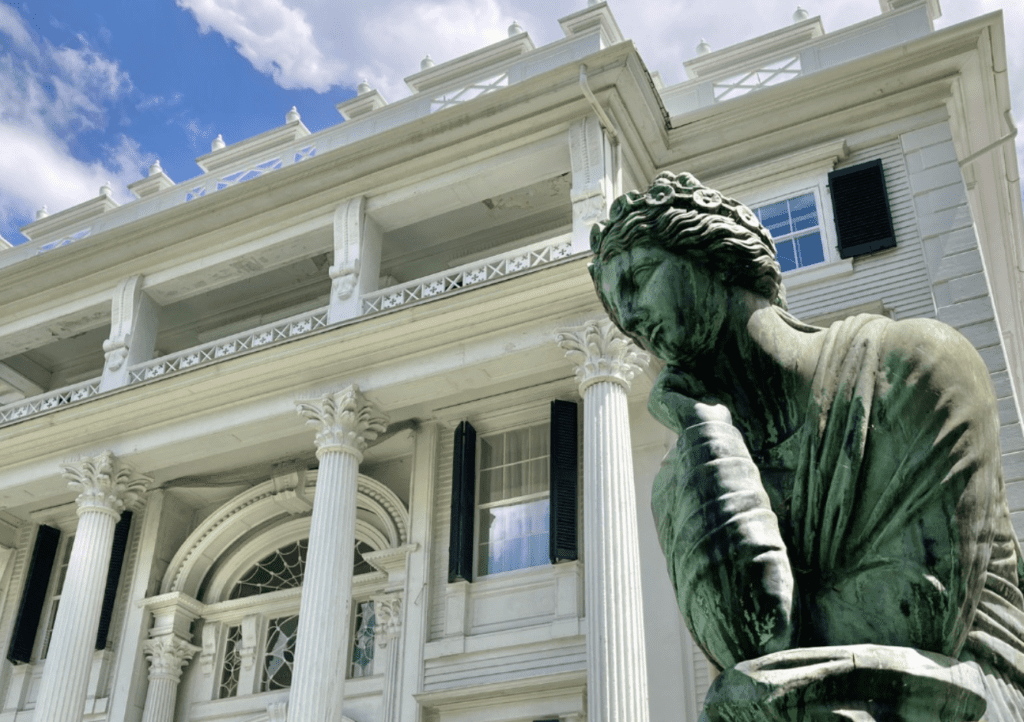 Statue in front of historic building facade.