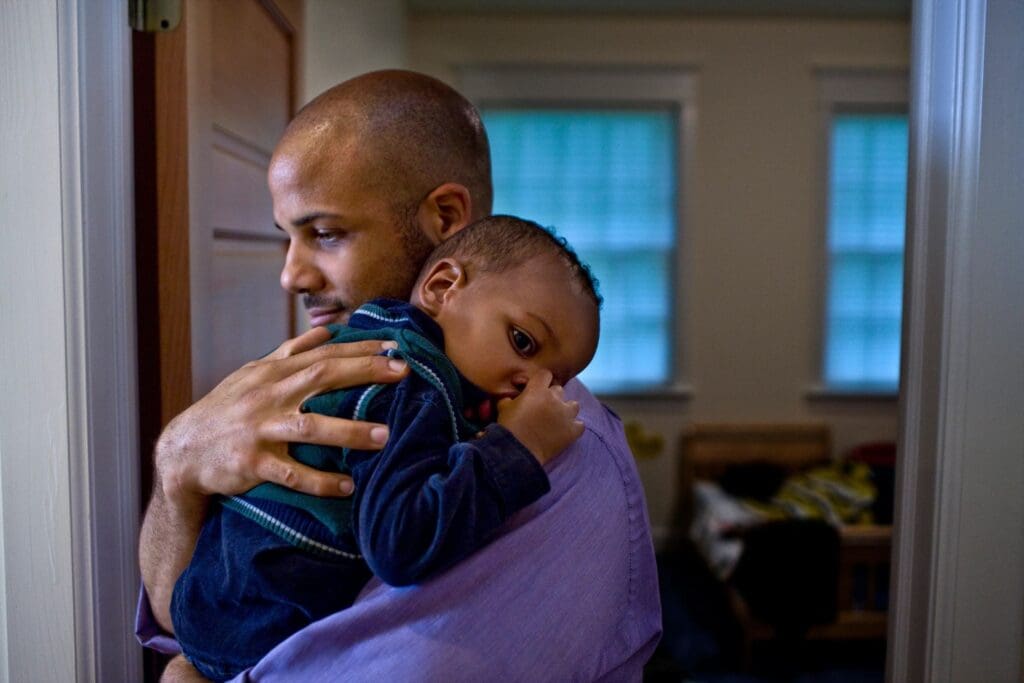 Man holding a baby in his arms.