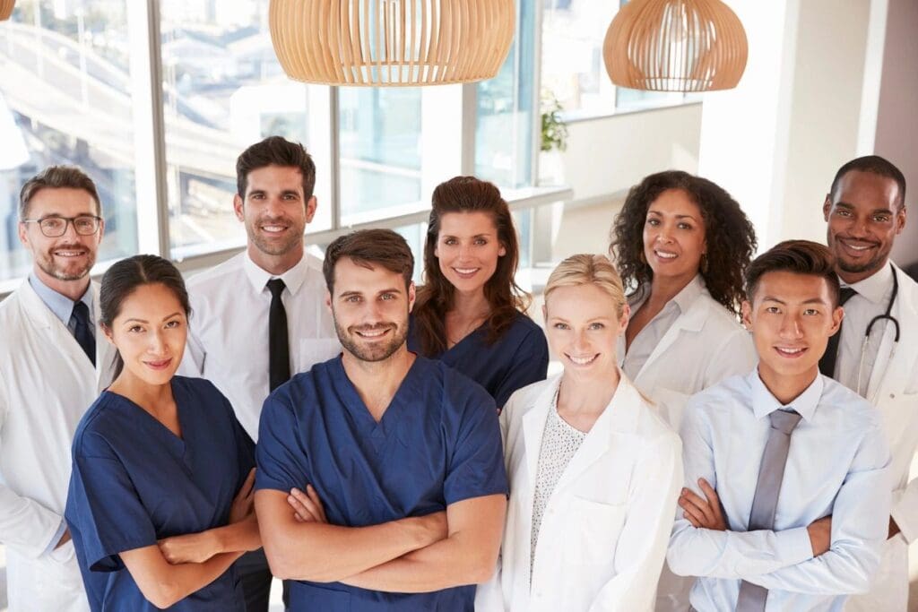 A diverse group of medical professionals standing confidently in a bright clinic.