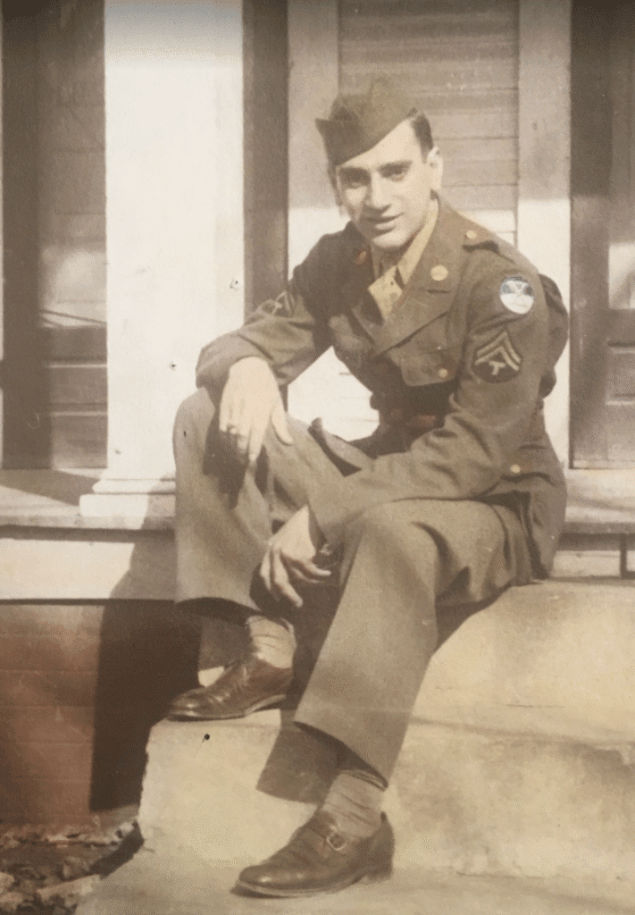 Young soldier in vintage military uniform sitting on steps.