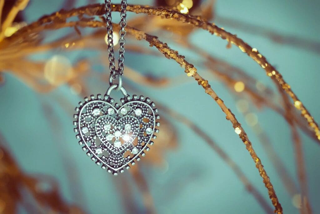 Intricate heart-shaped pendant hanging on a delicate chain.