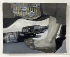 Close-up of a vintage shoe and a car key on a surface.