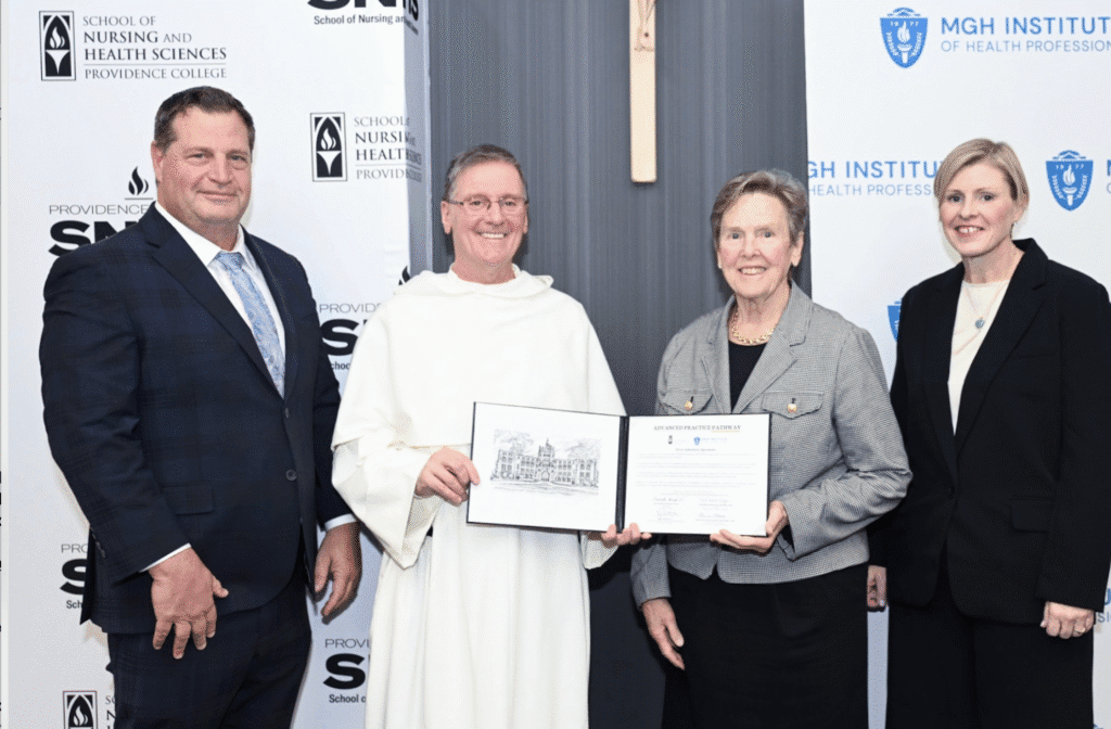 Three people holding an award certificate and smiling at a formal event.