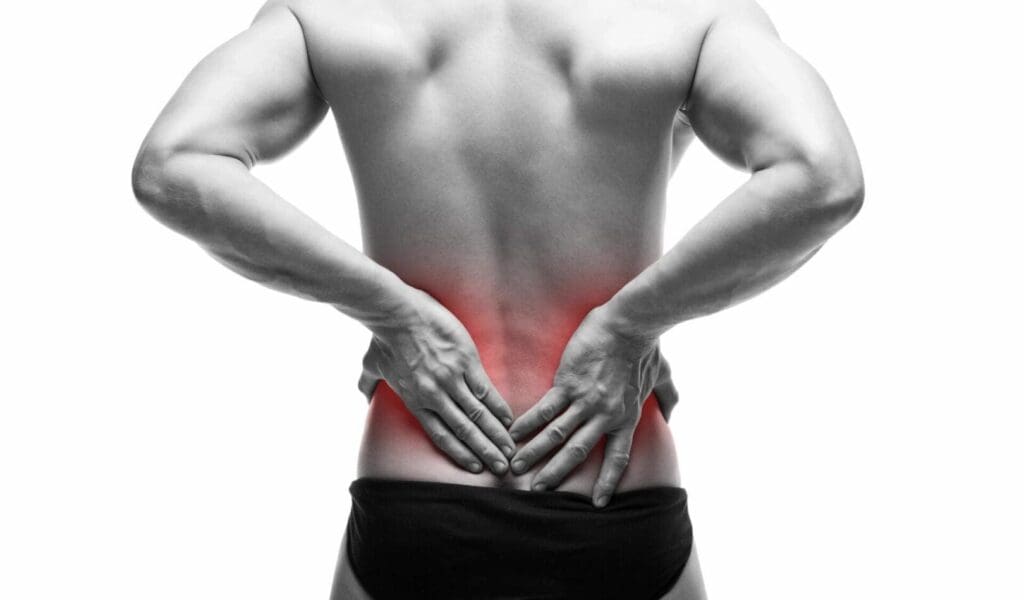 Man holding his lower back in pain, highlighting lower back discomfort.