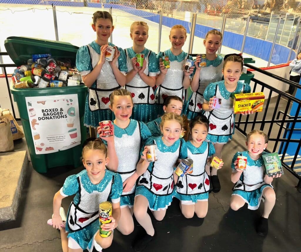 A group of young dancers holding trophies and certificates.