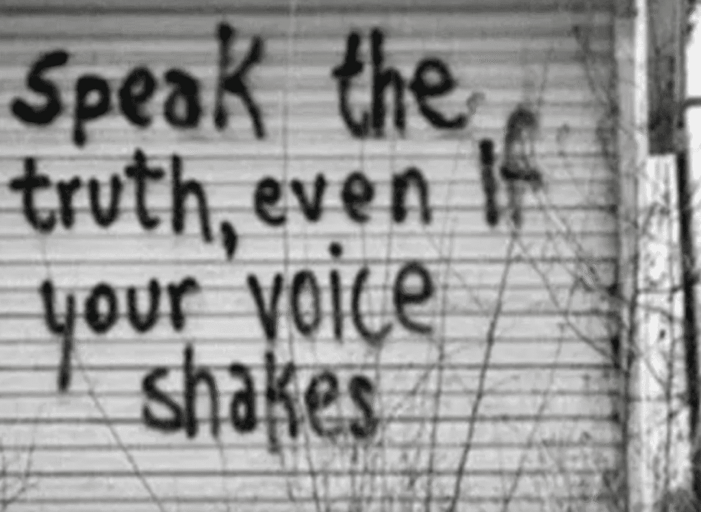 Inspirational graffiti urging to speak the truth despite fear.