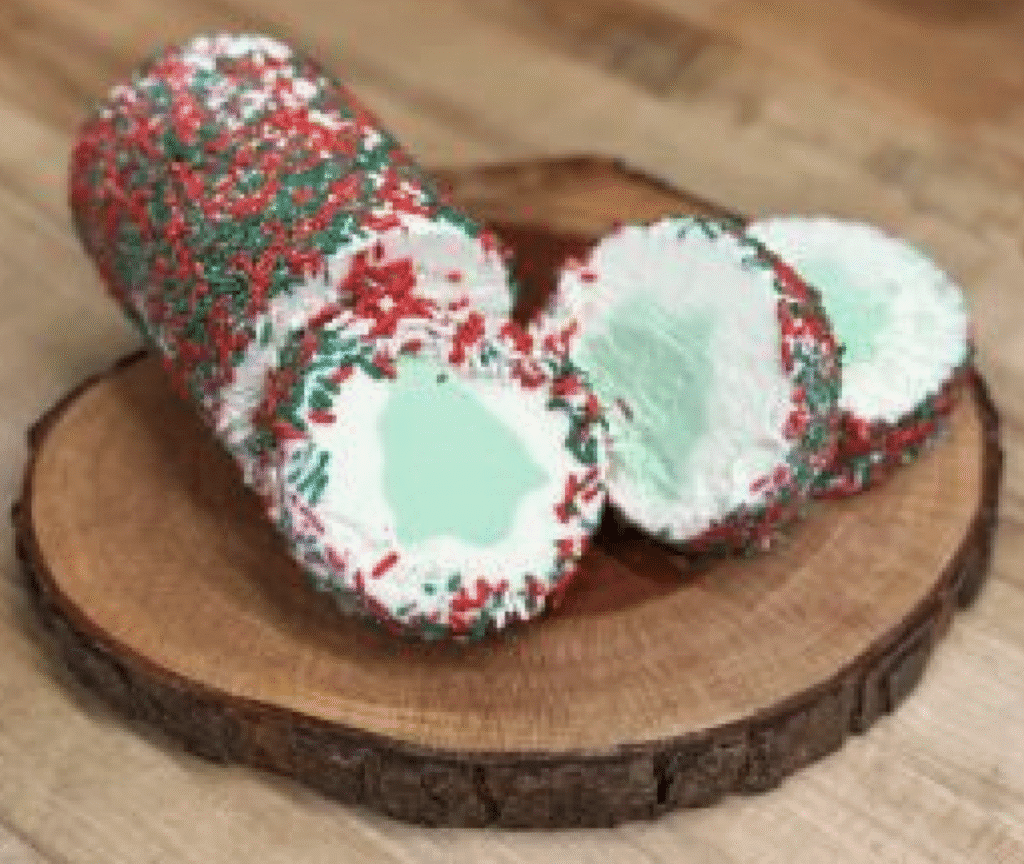 Festive peppermint candy cane logs coated with crushed red and green sprinkles.