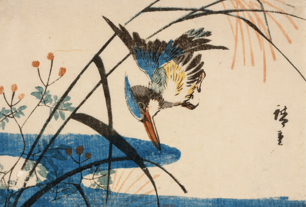 A colorful bird perched near water with reeds.