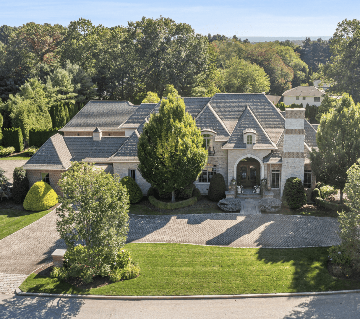Large suburban house with multiple gables and a spacious driveway.