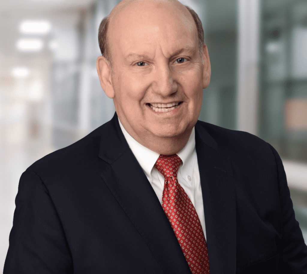 Professional businessman in a suit smiling indoors.
