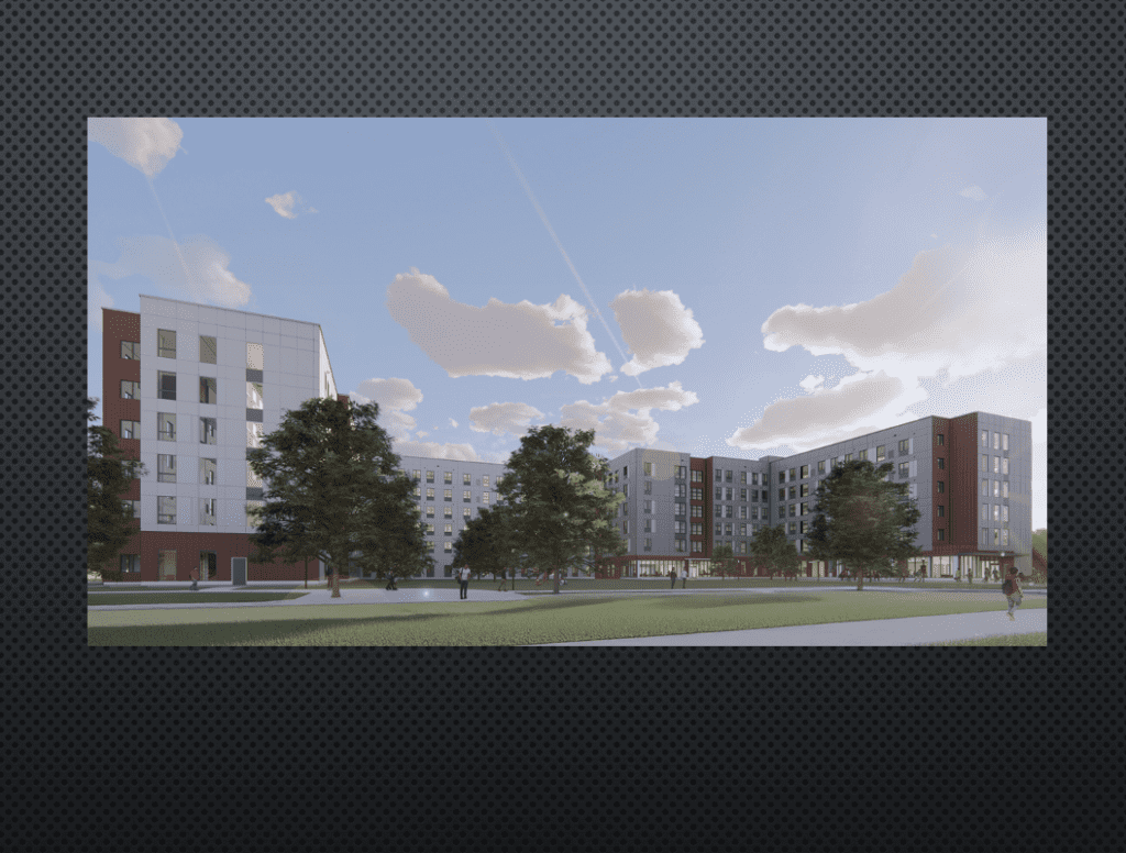 Modern residential buildings surrounding a spacious green courtyard under a blue sky.