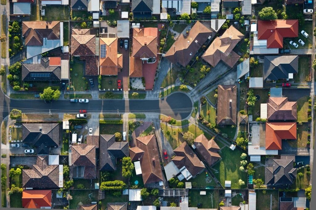 Aerial view of suburban neighborhood with houses and yards.