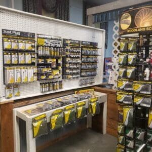 A display of various Yamaha guitar strings and accessories in a store.