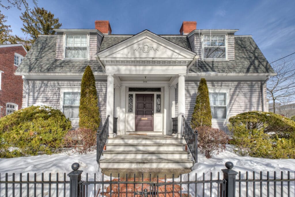 Elegant historic mansion with a grand entrance and symmetrical design.