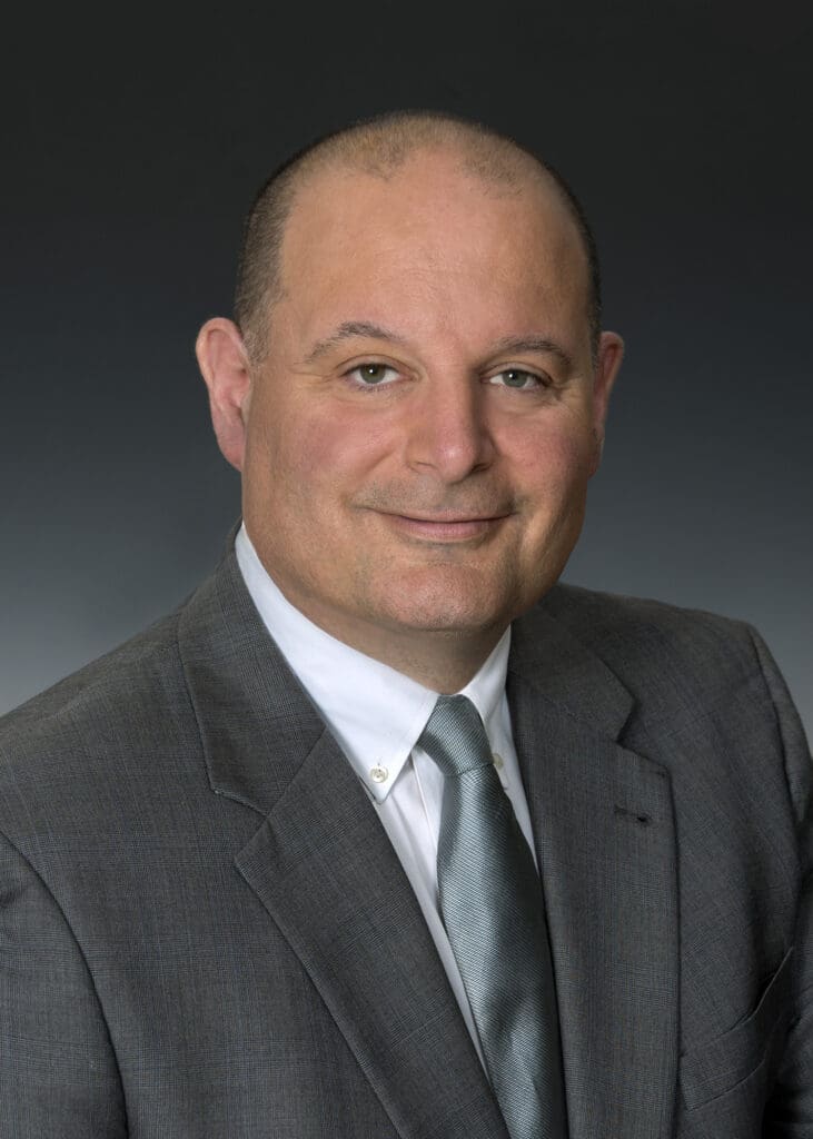 Professional portrait of a man in a suit and tie.