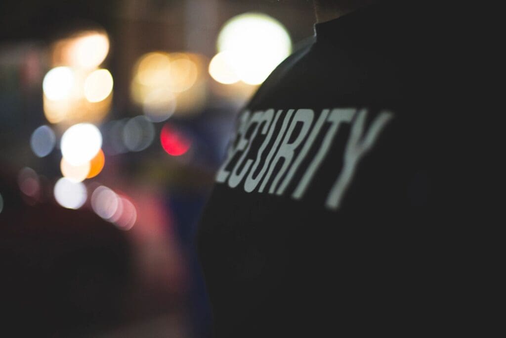 Close-up of a security officer's jacket at night.