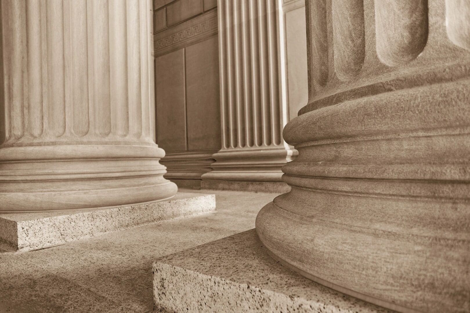 Close-up of classical stone columns with fluted shafts.