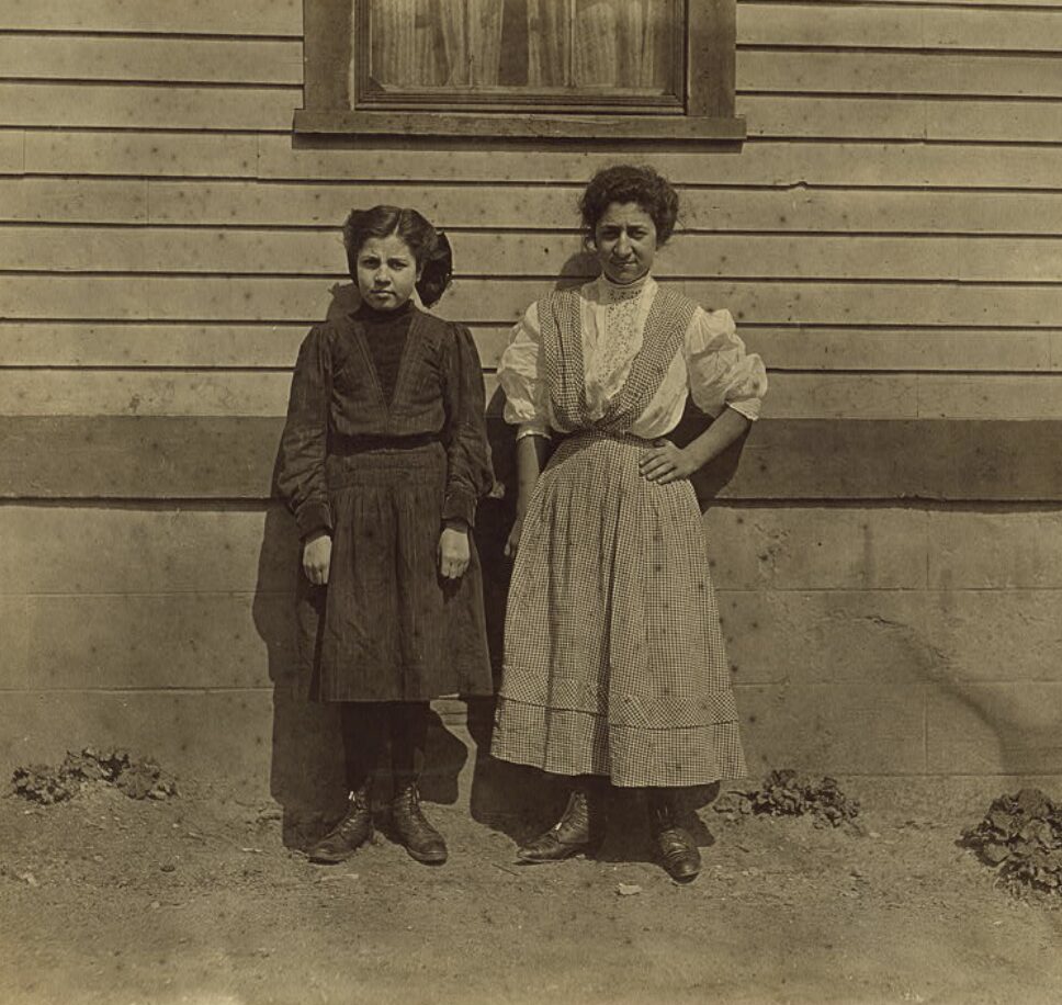 Two Portuguese girls working in Royal Mill, River Point, R.I. Younger girl, Mary Fartado "Works on lace." Been in mill 3 years. Other girl 3 years too. they do not speak English. Location: River Point, Rhode Island.