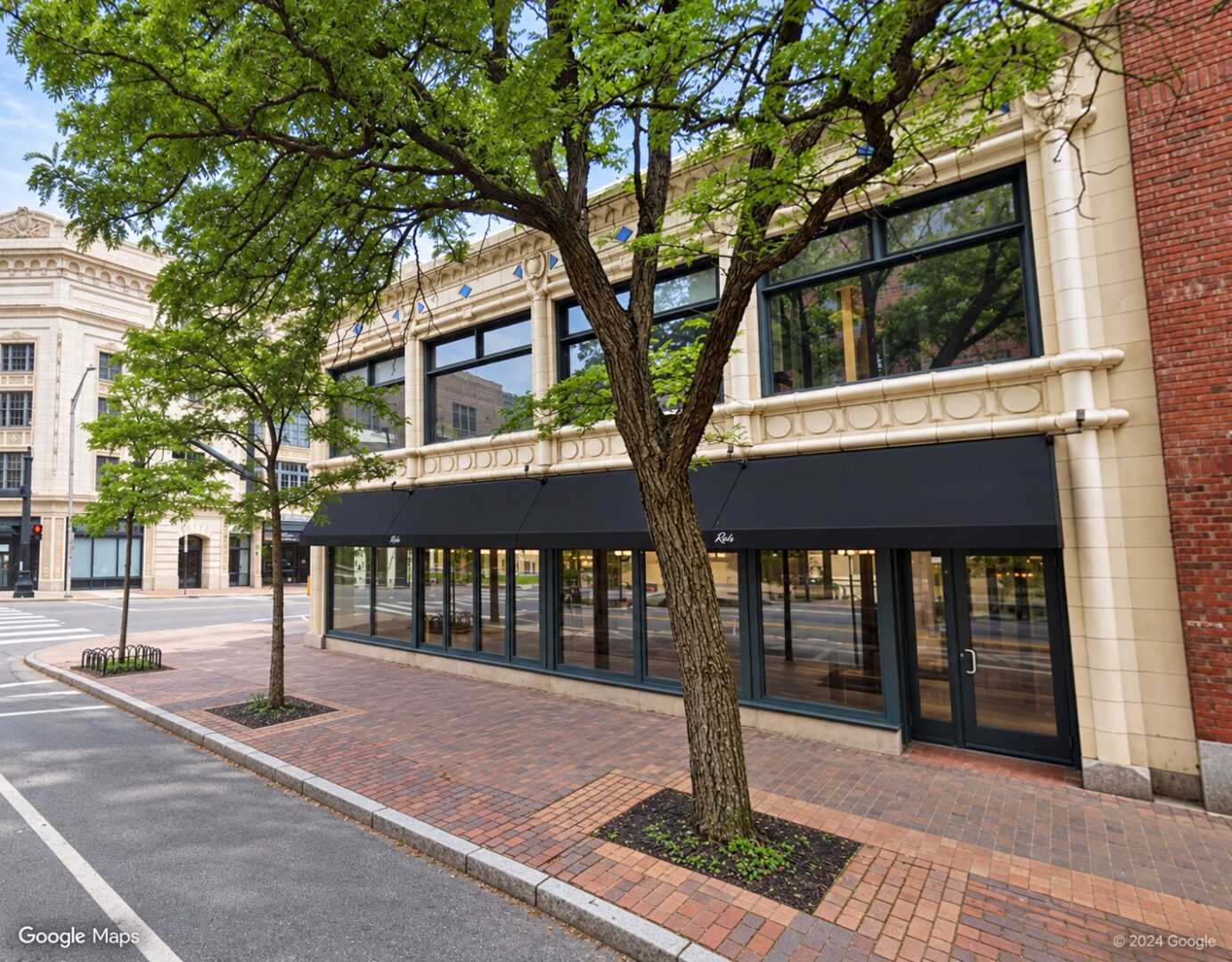 Unobstructed tree-lined storefront streetscape