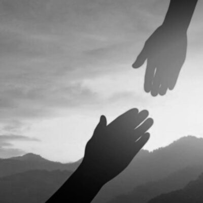 Helping hand reaching out to another.