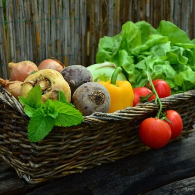 A basket of vegetables on top of a table.