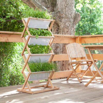 Vertical garden and chairs on wooden deck.