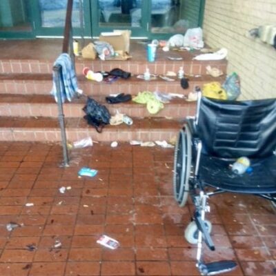 A wheelchair on the steps of a building.