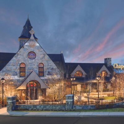 The front of a stone building at dusk.