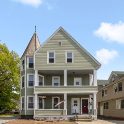 A two story house with two porches and a front porch.