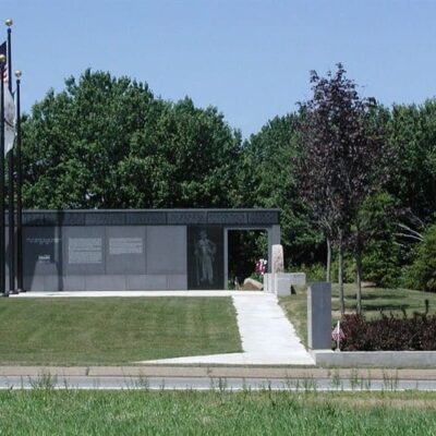 A small building with an american flag in front of it.