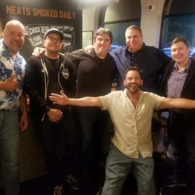 A group of men posing for a picture in a restaurant.