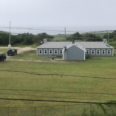 An aerial view of a house near the ocean.